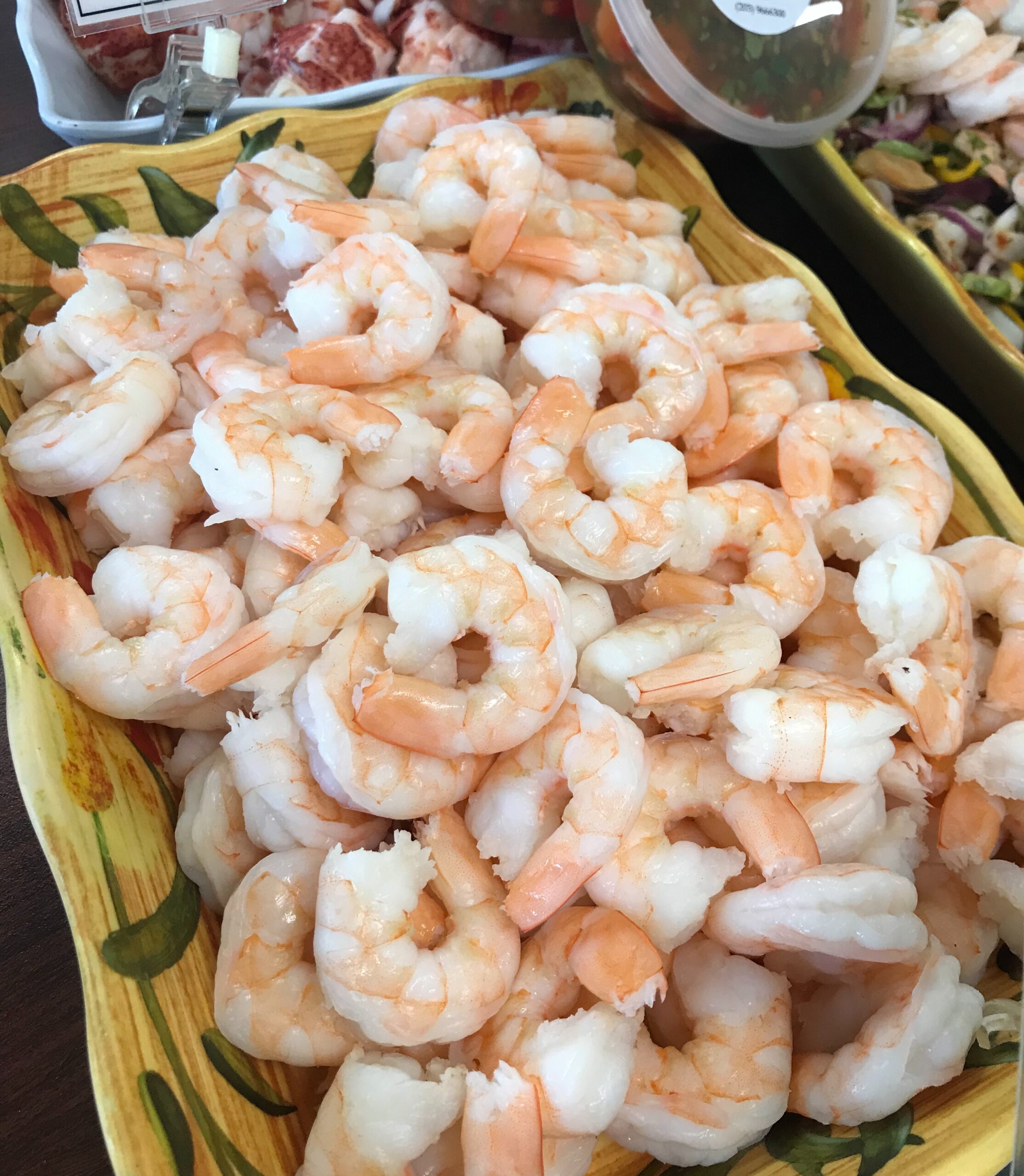 A platter of cooked and peeled shrimp