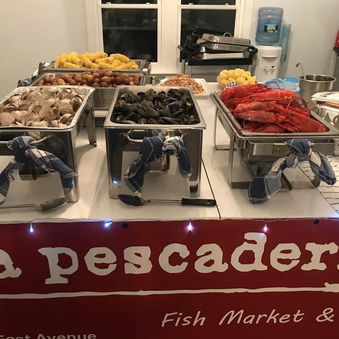 Catering buffet with clams, mussels, lobsters, corn and potatoes