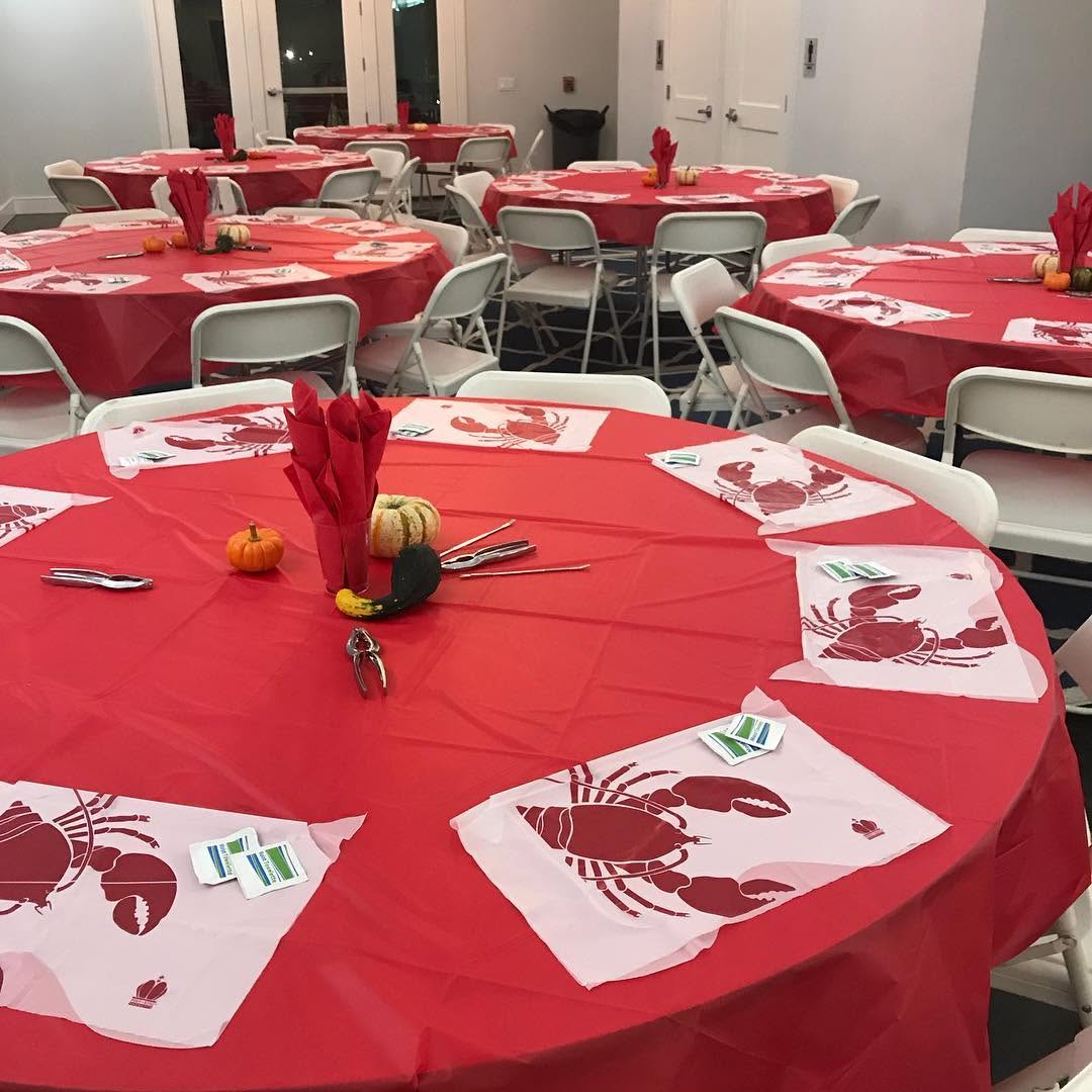 Event tables set with red tablecloths and lobster bibs