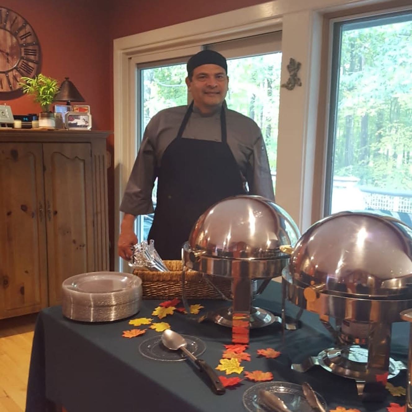Chef Rafael behind a catered buffet in a client’s home